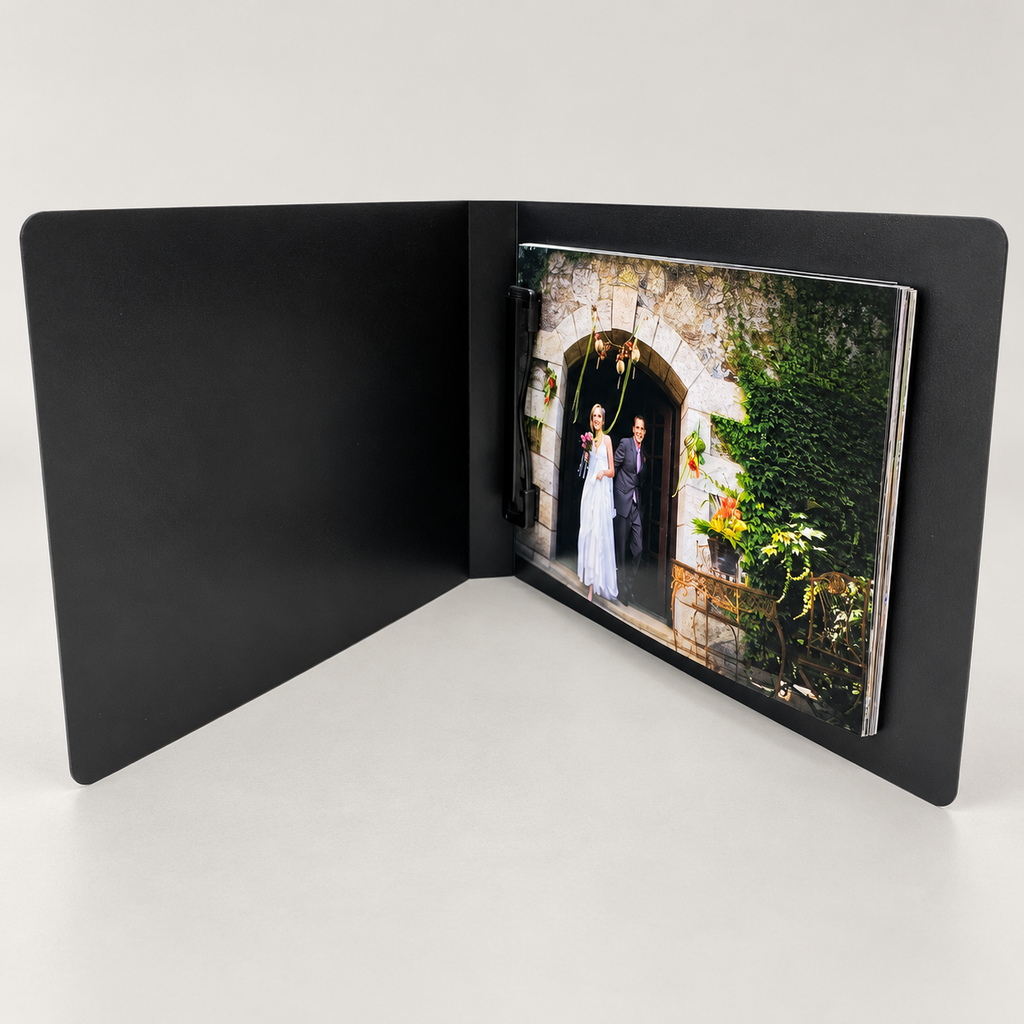 Kwik Film black clip photo flip book, shown open with example prints; choose print size and pack quantity on the product page.