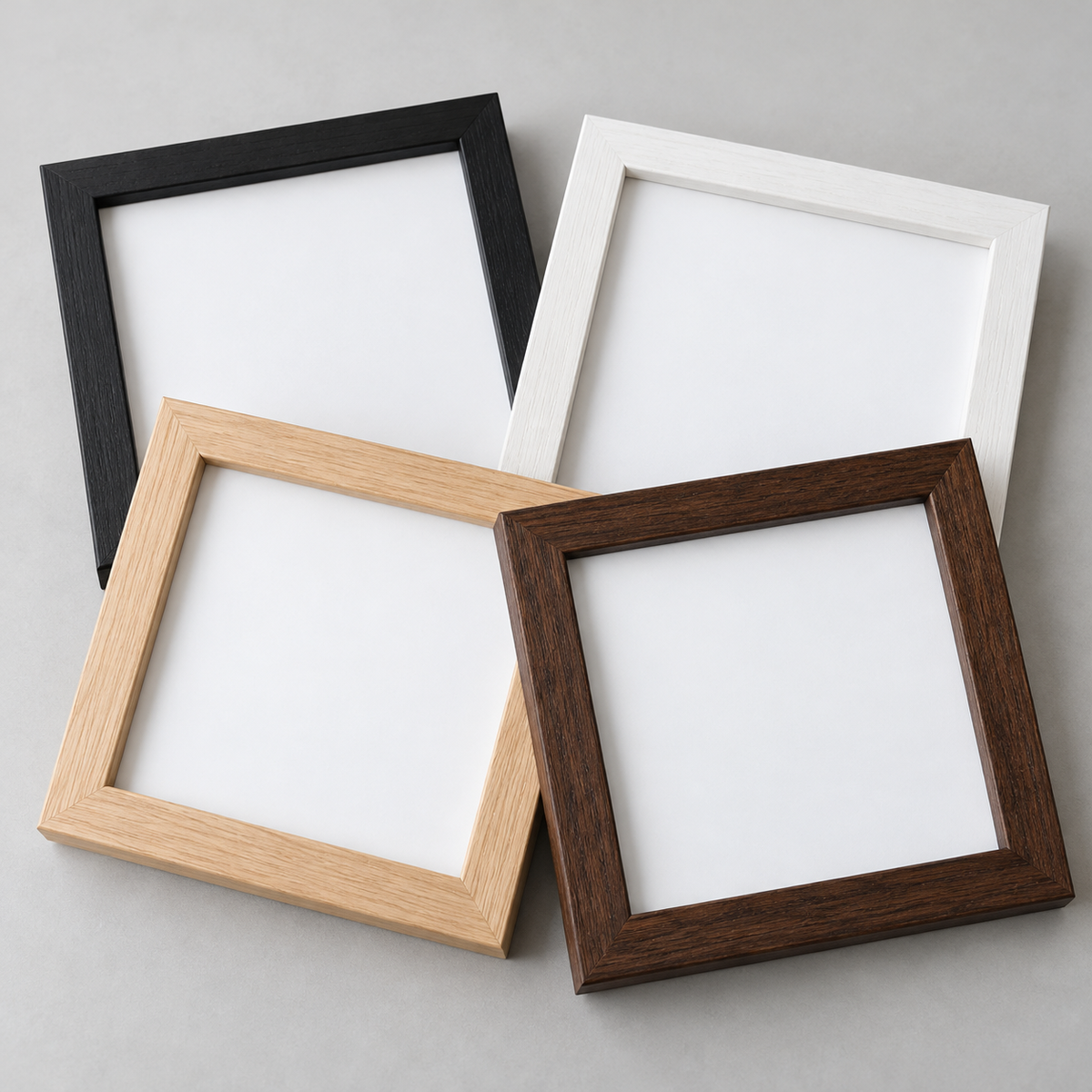 Illustrative empty wooden frames in black, white, light wood and dark wood finishes; frames are sold individually.
